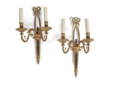 A pair of gilt and patinated metal twin light wall appliques in late 18th century tast