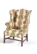 A Green and white patterned upholstered armchair in George III style