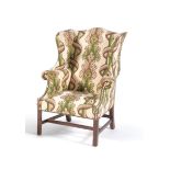 A Green and white patterned upholstered armchair in George III style
