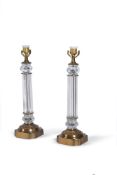 A pair of gilt metal and moulded glass columnar table lamps