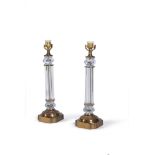 A pair of gilt metal and moulded glass columnar table lamps