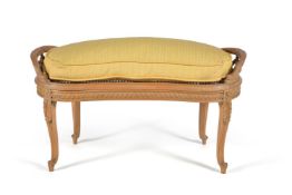 A stripped walnut window seat or long stool in Louis XVI style