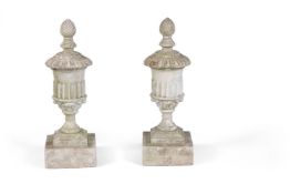 A pair of white painted stone composition finials cast as urns