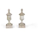 A pair of white painted stone composition finials cast as urns