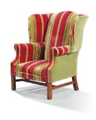 A George III style beechwood wing armchair