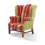 A George III style beechwood wing armchair