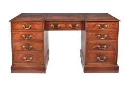 A modern reproduction mahogany desk of inverted breakfront form