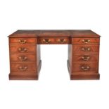 A modern reproduction mahogany desk of inverted breakfront form