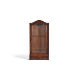 A walnut display cabinet with arched top and single glazed door above a waved base with squared feet