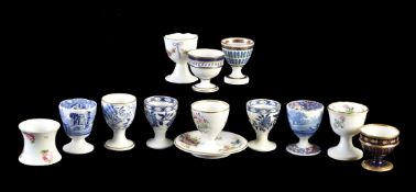 An assortment of English, mostly porcelain egg-cups