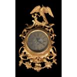 A giltwood cartel timepiece