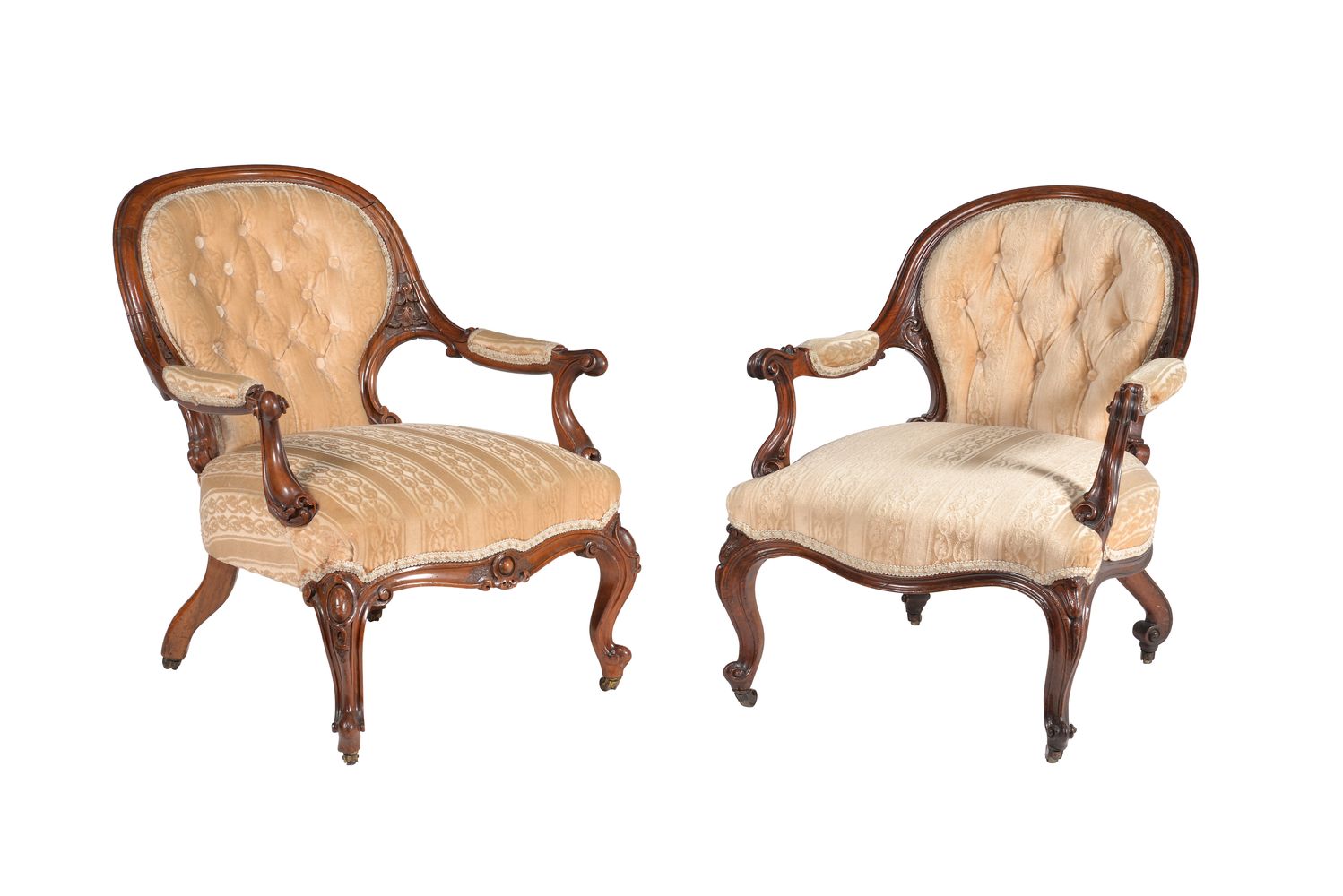 A matched pair of Victorian walnut and upholstered open armchairs