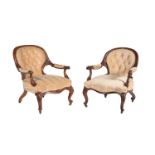 A matched pair of Victorian walnut and upholstered open armchairs