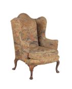 A walnut and upholstered wing armchair in Queen Anne style