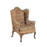 A walnut and upholstered wing armchair in Queen Anne style