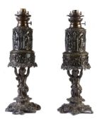 A pair of lacquered spelter table oil lamps in Historicist taste