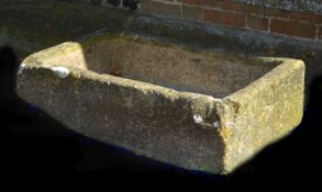 A rough hewn stone trough or basin