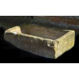 A rough hewn stone trough or basin