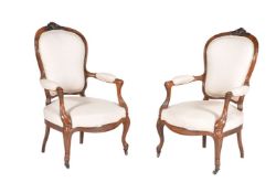 A pair of French carved fruitwood and upholstered fauteuils