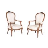 A pair of French carved fruitwood and upholstered fauteuils