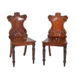 A pair of William IV mahogany hall chairs