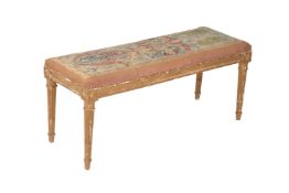 A French giltwood and tapestry upholstered long stool in Louis XVI style