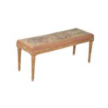 A French giltwood and tapestry upholstered long stool in Louis XVI style