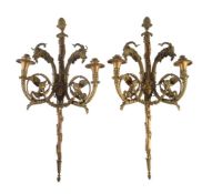 A pair of gilt bronze twin light wall appliques after designs by Pierre Gouthière (French