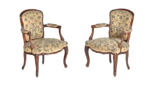 A pair of French stained beech and needlework upholstered armchairs