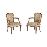 A pair of French stained beech and needlework upholstered armchairs