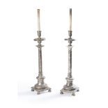 A pair of Italian turned and silvered standard lamps in the manner of altar sticks