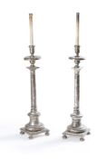 A pair of Italian turned and silvered standard lamps in the manner of altar sticks