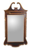 A mahogany and parcel gilt wall mirror