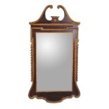 A mahogany and parcel gilt wall mirror