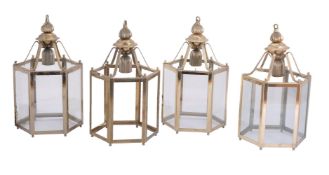 A set of four gilt metal and glazed hexagonal hall lanterns