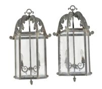 A pair of glazed and metal wall lanterns