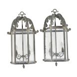 A pair of glazed and metal wall lanterns