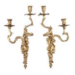 A set of four gilt bronze twin light figural wall appliques in Louis XV style