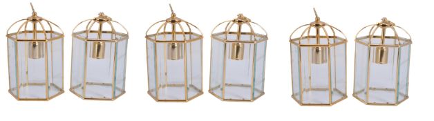 A set of four gilt metal and glazed hexagonal hall lanterns