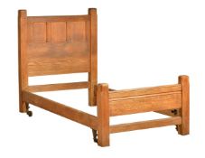 An Arts & Crafts oak single bed