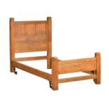 An Arts & Crafts oak single bed