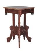 A carved and stained walnut occasional table