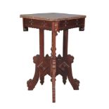 A carved and stained walnut occasional table