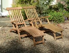 A pair of teak 'steamer' reclining chairs