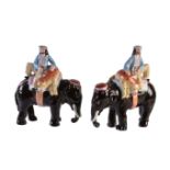 A pair of Staffordshire pottery caparisoned elephants with mahout and tiger of William Kent type