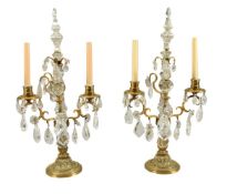 A pair of cut glass and rock crystal mounted gilt metal twin light candelabra in 18th century taste