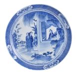 An Arita Porcelain Saucer Dish of typical circular form decorated in underglaze-blue with a scene of