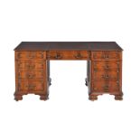 A mahogany twin pedestal desk in George III style