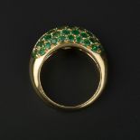 A diamond and emerald dress ring