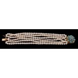 A cultured pearl bracelet with a turquoise and diamond clasp